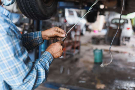 The mechanic is checking the undercarriage of the car.の写真素材