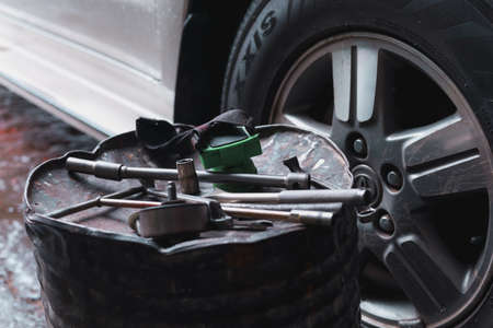 The mechanic is checking the undercarriage of the car.の写真素材