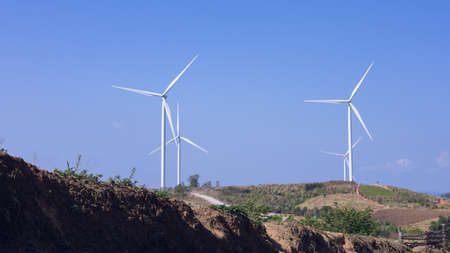 Offshore wind power and energy farm with many wind turbines on the mountainの写真素材
