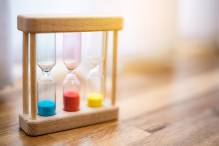 Colorful hourglasses with blurred background cute conceptの写真素材