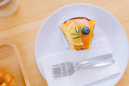 Top view piece of orange cake and sliced orange topping. Cake with orange mousse with copy spaceの写真素材
