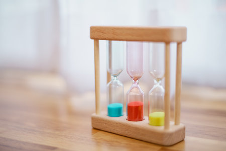 Colorful hourglasses with blurred background cute conceptの写真素材