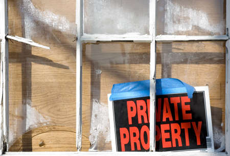 Funny property sign on a wreched buildingの写真素材