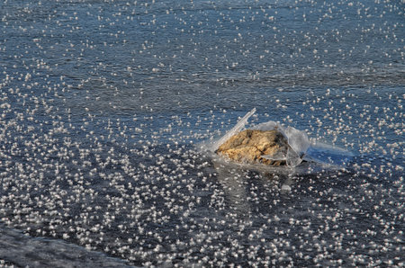 ice covered with snowflakes and stonesの写真素材