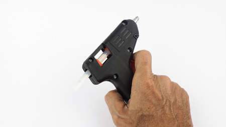 Hold the handle Electric hot glue gun isolated on white backgroundの写真素材