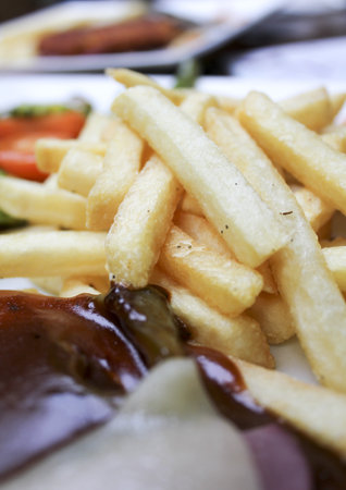 Fried potatoes with bbq sauce, salami and luncheon