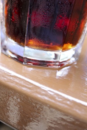Wet glass of cola with ice cubesの写真素材