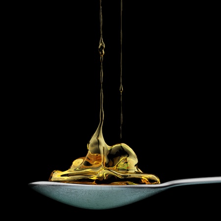 Honey Pouring on spoon の写真素材