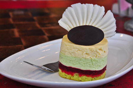 Piece of mousse cake on white dishの写真素材