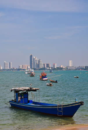 fishing boats with background of Pattaya cityの写真素材