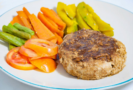 Pork Steak with vegetables on a white plate