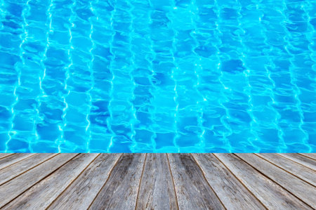 Rippled pattern of blue water and wood background