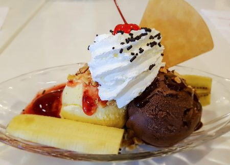 Banana split with ice cream and topping, selective focus