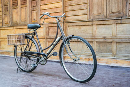 Vintage bcycle standing near wood wallの写真素材