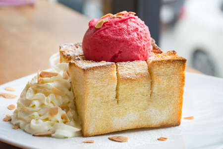 Honey toast with raspberry sorbet ice cream and whipping creamの写真素材