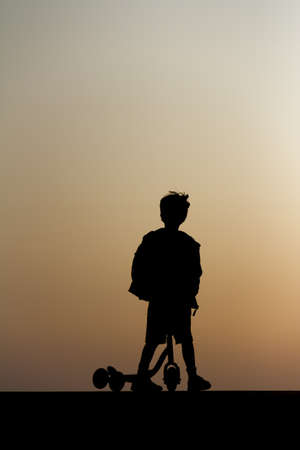 silhouette of a boy on a bikeの写真素材