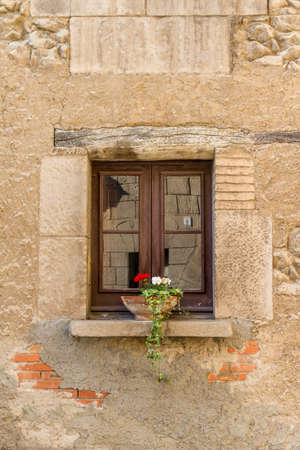 stone window with a flower potの写真素材