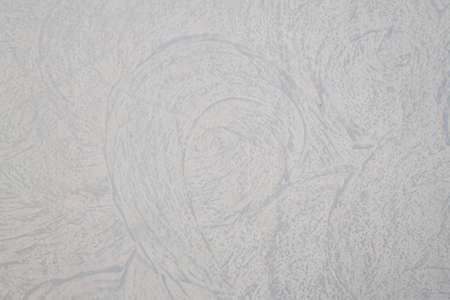 A white textured plaster wall with interesting designの写真素材