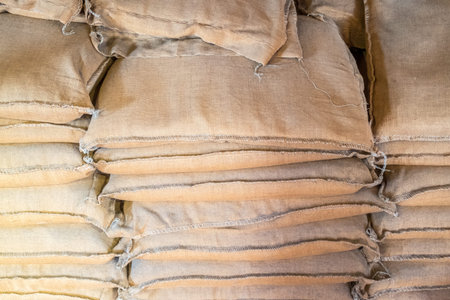 A large stack of brown flour sacksの写真素材