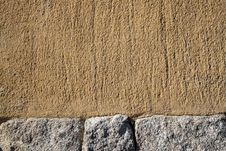 Garden wall made of a mix of stone block and sand stoneの写真素材