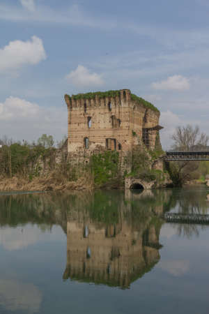 A small village in the Tuscany area of Italy by a calm lakeの写真素材