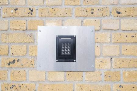 keypad on a brick wall