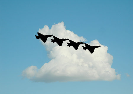 flight formation of jets over clouds