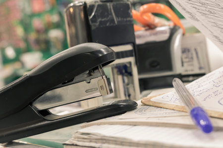 Office supplies in the form of a stapler, pen, and notepad printingの写真素材