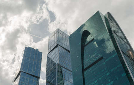 High glass building with offices, a business center on the background of cloudsの写真素材