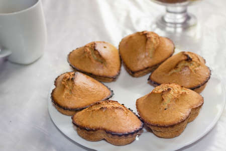 cakes on a table,fresh homemade cupcakes in the shape of heartの写真素材