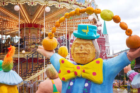 Juggler circus with pumpkins against the backdrop of a merry-go-round, halloweenの写真素材