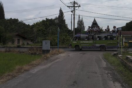 Lake Toba, Indonesia - January 18, 2016: School Bus with Children on Roof, Samosir Island in Lake Toba, North Sumatra Indonesiaのeditorial素材