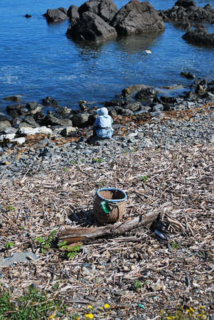Woman sitting down and resting at beachの写真素材