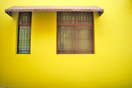 Bright yellow wall with windowの写真素材