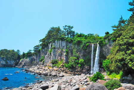 Far shot of majestic waterfall with sky backgroundの写真素材