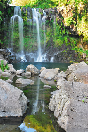 Low shot of majestic waterfall with huge rocks in the foregroundの写真素材