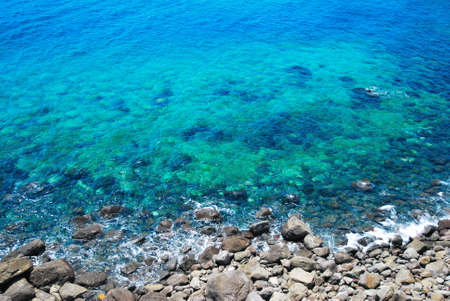 Clean, unpolluted shore covered with stones and pebblesの写真素材