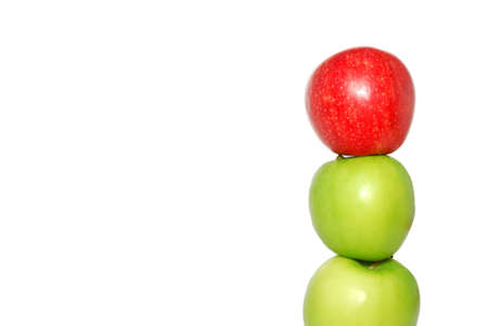 A group of apples with a single red apple standing out from the crowdの写真素材