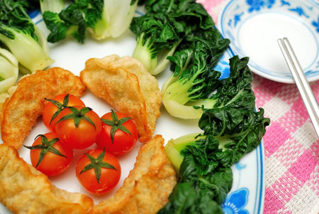 Sumptuous looking Chinese style fried vegetarian dumplings and vegetables. Suitable for concepts such as diet and nutrition, healthy eating and healthy lifestyle, and food and beverage.の写真素材