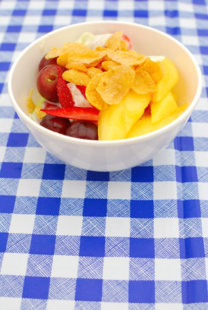 Fruit salad made from a variety of fruits, topped with cereal for a healthy and nutritious...