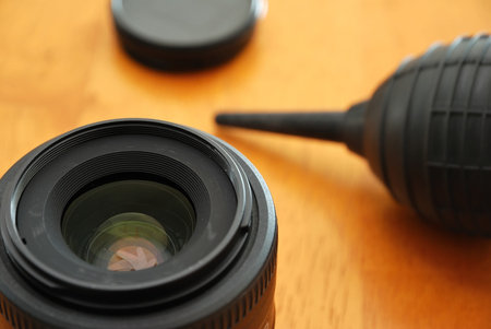 Cleaning of camera lenses with a blower. For concepts such as cameras and photography, imaging, and cleaning and maintenance.の写真素材