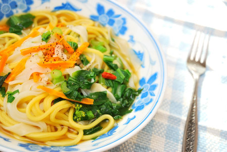 Asian style soup noodles cooked with a variety of vegetables to signify healthy lifestyle, food and...