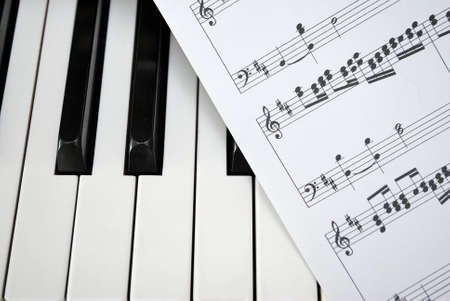 Black and white piano keyboard with music sheet. For concepts like music and creativity.の写真素材