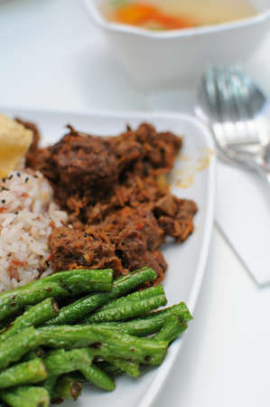 Vegetarian rendang chicken or mutton with unpolished red rice. Suitable for concepts such as diet and nutrition, healthy lifestyle, and food and beverage.の写真素材
