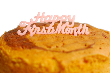 Delicious butter sponge cake for celebrating a baby's first month anniversary isolated on white...