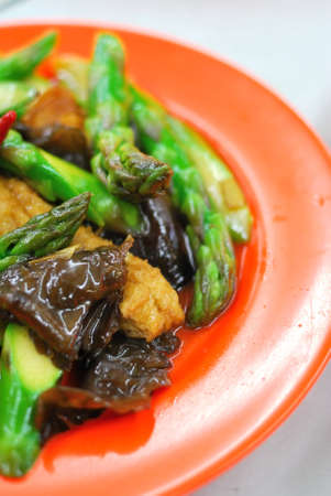 Chinese style stir fried asparagus cooked with black fungus and various vegetable ingredients. Suitable for food and beverage, healthy lifestyle, and diet and nutrition.の写真素材