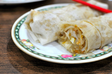 Asian style vegetable roll made with fillings including cooked vegetables. Suitable for concepts such as healthy lifestyle, food and beverage, and diet and nutrition.の写真素材