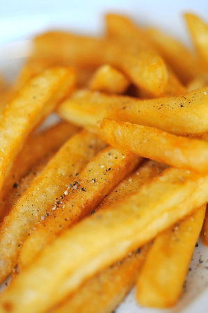 Macro shot of fried potato sticks with sprinkled pepper.の写真素材