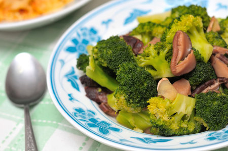 Asian style sit fried healthy fresh broccoli with black mushrooms.の写真素材