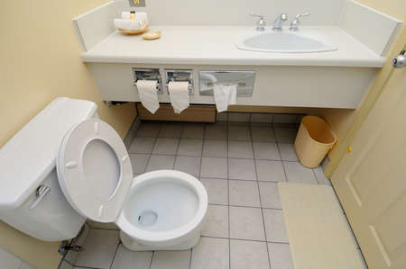 Bright and white toilet area and wash basin.の写真素材